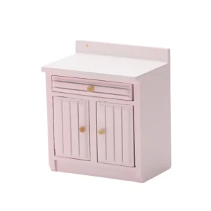 Delicate blush pink miniature kitchen cabinet featuring a protective backsplash, single drawer, and double doors with vertical grooved panels, perfect for romantic dollhouse settings.