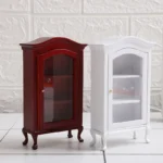 Miniature dollhouse display cabinet in rich burgundy red featuring curved crown top, glass door with brass knob, three interior shelves, and elegant Queen Anne legs, perfect for 1:12 scale dollhouse furniture.