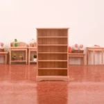 Miniature dollhouse natural wood bookcase featuring six adjustable shelves with classic paneled backing, crown molding top and traditional base, perfect for 1:12 scale dollhouse furniture collection.