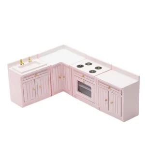 Four-piece dollhouse kitchen set in soft pink featuring an L-shaped design with sink unit, corner cabinet, stove unit with four burners, and end cabinet, all with vertical panel doors and gold hardware.