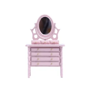 Miniature dollhouse dresser in soft pink featuring an adjustable oval mirror, four drawers with gold knobs, and delicate turned legs in Victorian style.