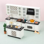 Three-piece dollhouse kitchen set in white with black countertops featuring two wall units with wine rack and range hood, plus matching island unit with dimensions display.