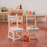 Miniature wooden chair with a simple design, perfect for dollhouse furnishings.