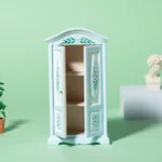 Miniature blue wardrobe with floral decorations and white panels, designed for dollhouse decoration.