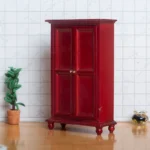 Miniature red wardrobe featuring classic double doors and elegant detailing, designed for dollhouse decoration.