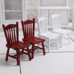 Miniature red wooden chair with a classic design, perfect for dollhouses and crafting projects.