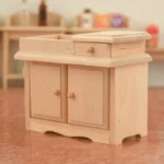 1:12 scale unfinished wooden dry sink featuring top basin compartment, single drawer, double doors, and scalloped base for dollhouse kitchen furniture.