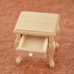 1:12 scale unfinished wooden nightstand with elegant Queen Anne style cabriole legs, single drawer with round knob, and curved sides for dollhouse bedroom furniture.