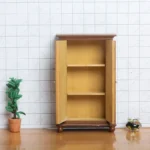 Miniature walnut wardrobe featuring double doors and elegant detailing, perfect for dollhouse decoration.