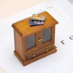 1:12 scale walnut-finished cabinet featuring two glass panel doors, bottom drawer with brass knobs, scalloped base, and traditional design for dollhouse display furniture.