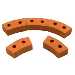 Set of 100 miniature curved terracotta bricks measuring 3cm x 1.3cm x 0.9cm, featuring dual mounting holes and curved design for creating arches and curved walls, in authentic clay orange color with smooth finish