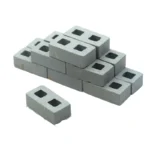 Set of 100 miniature grey concrete cinder blocks measuring 2.8cm x 1.4cm x 0.9cm, featuring two square holes, authentic concrete texture and precise dimensions, perfect for 1:12 scale construction and architectural models