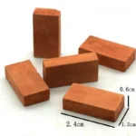 Set of 100 miniature terracotta rectangular building bricks measuring 2.4cm x 1.2cm x 0.6cm, featuring authentic red clay color and natural surface texture, perfect for 1:12 scale dollhouse construction and architectural models