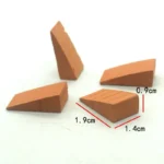 Set of 100 miniature terracotta wedge-shaped blocks measuring 1.9cm x 1.4cm x 0.9cm, featuring angled design with textured surface lines, perfect for 1:12 scale ramps, transitions, and architectural details